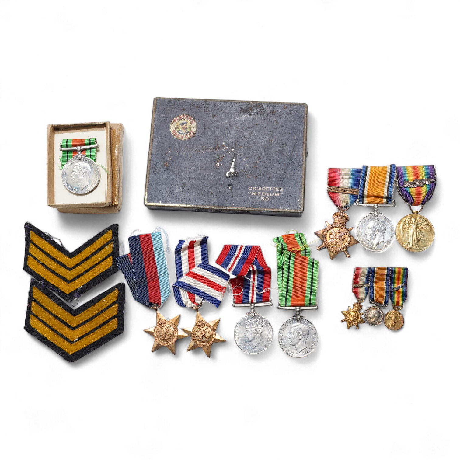 A First World War Mons Star trio awarded to Capt. A.D. Lowdell, with a clasp for 5th Aug-22nd Nov 1914, and oakleaf - mention in dispatches, together with the miniature set, plus a WWII Defence medal in its original card